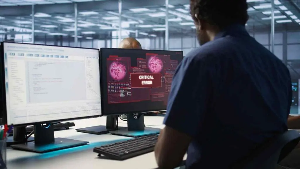 a cyber security expert is looking at a computer