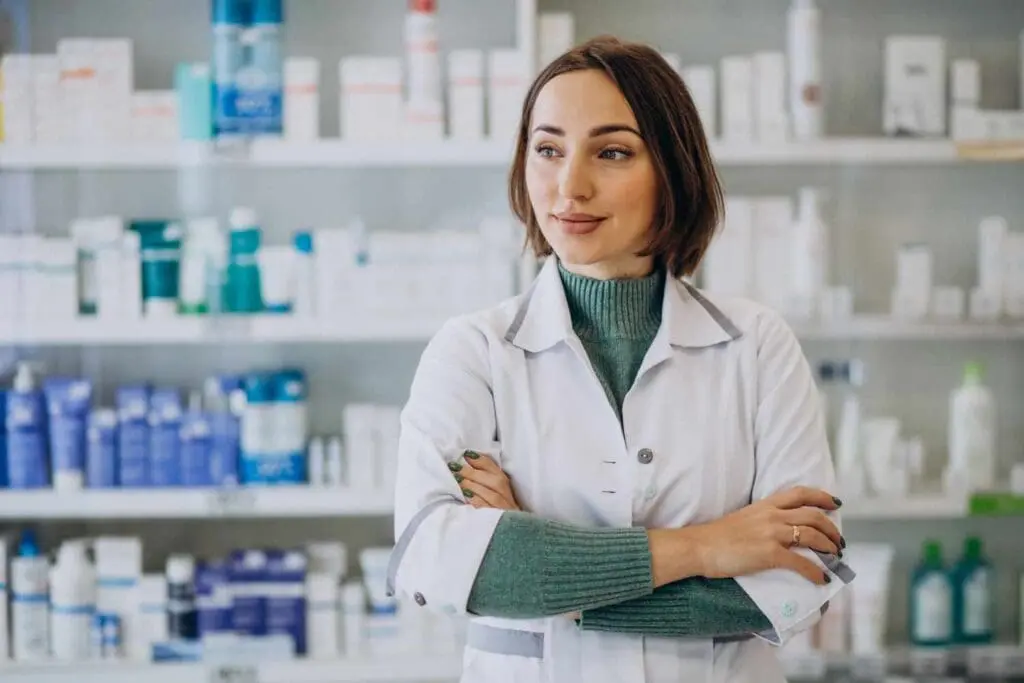 a_woman_with_a_pharmacy_diploma_online_is_posing_for_a_picture_in_a_pharmacy