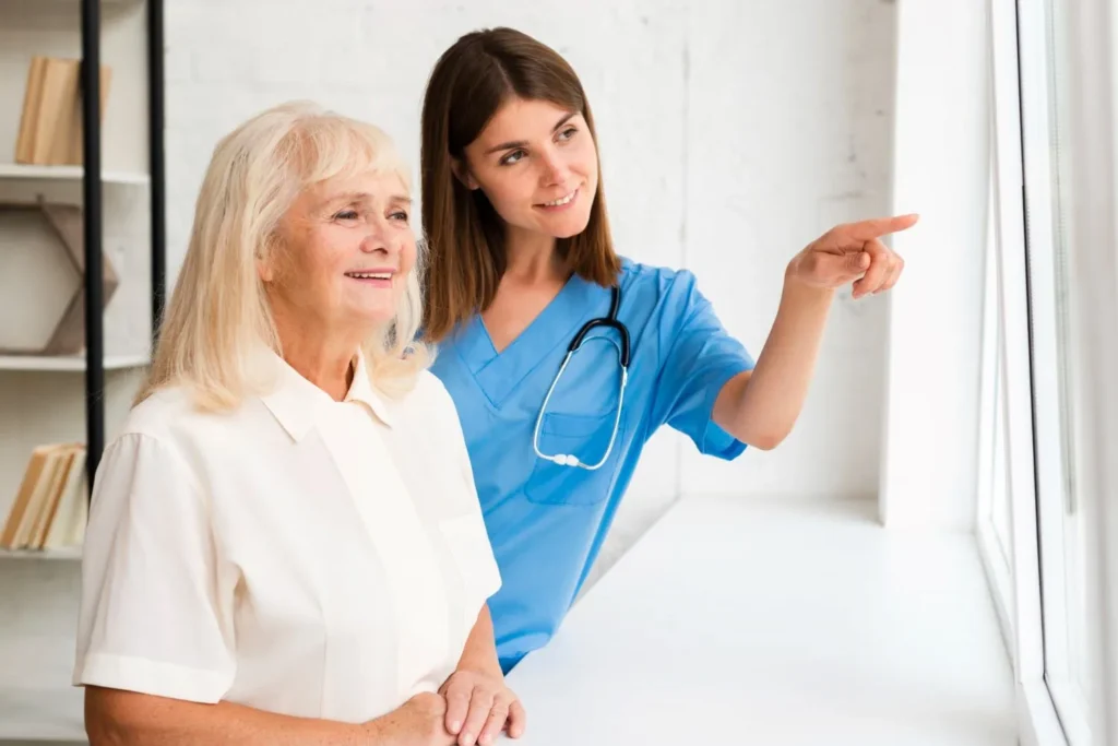 a health care assistant helping a woman