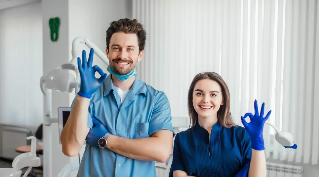 two professionals who did dental assistant courses smile